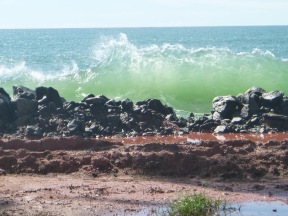 The sea attacking the coastline.